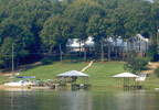 Talladega, Alabama (AL) Bed & Breakfast: All guest rooms are large, and 3 living rooms make it easy to relax and enjoy oneself indoors as well as out. Outdoors you'll find beach area, pier, 10 acres of woods, nature trails, golf carts, 100 foot walkway/deck back porch with plants, flowers and fountain, and 5 decks. 3 high definition tvs-tivo, movie night, boat rides, wi-fi, hot tub, fire pit.
