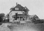 This turn-of-the-century, three-story, yellow frame house was built in the American Four Square architectural style and adjoins an 18-hole, public golf course. Lake Wawasee can be seen through the trees from several second story floor windows. 