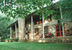 The Old Stone Inn in Waynesville, North Carolina offers the feel of a rustic hunting lodge with cozy, simple rooms and lots of privacy, regional antiques, handmade quilts on wonderful beds, mountain and woodland views.