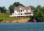 Our home was built on a farmstead in 1918. We moved it onto our lake property late in 1997, and completely renovated the house in the following months. It is a four story home, with three bedrooms dedicated to our guests. The view from these rooms is delightful. 